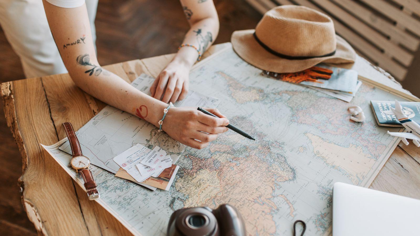 Planning a trip with a world map, passports and notes spread on the table