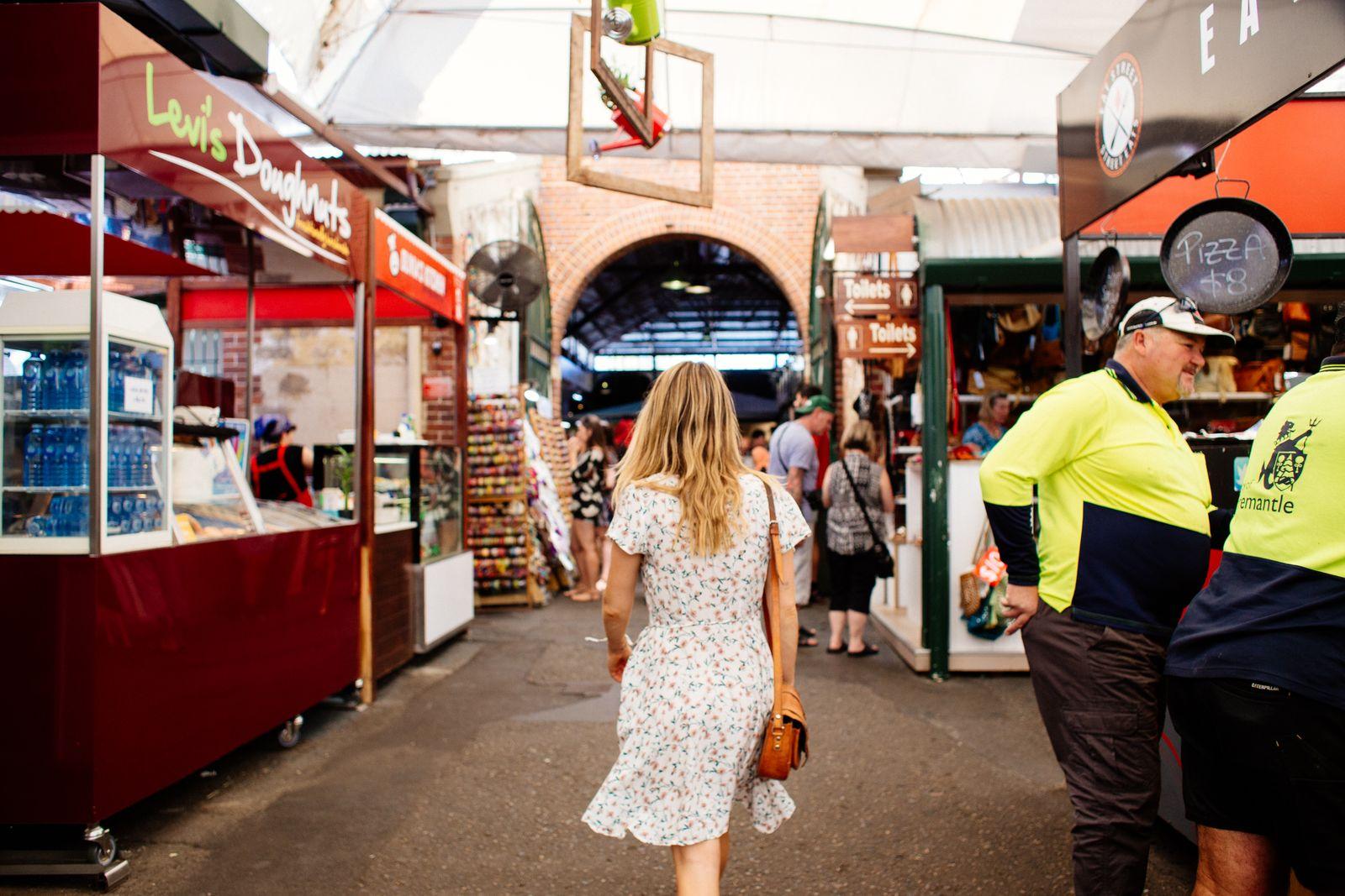Walking a lively indoor market, list in hand