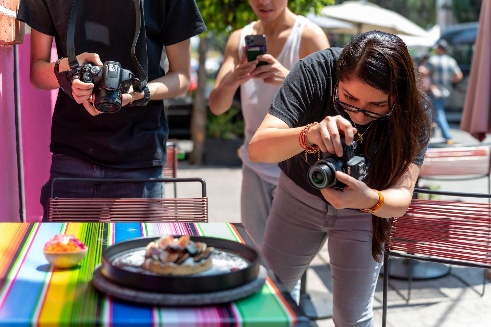A whole table of creators shooting the same dish